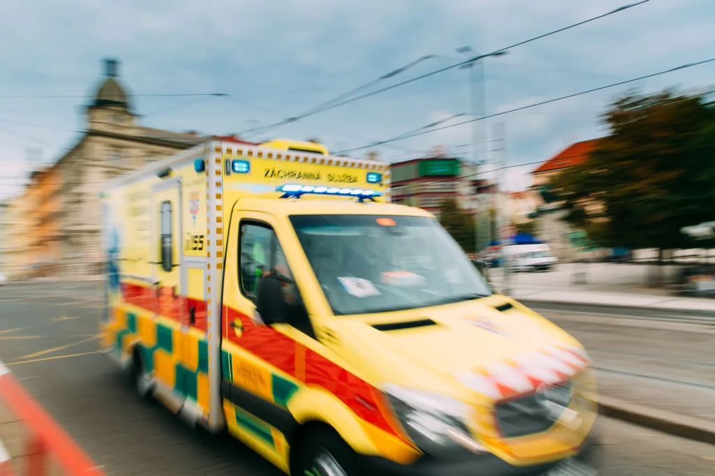 An ambulance zooming through the streets of Prague, Czech Republic.
