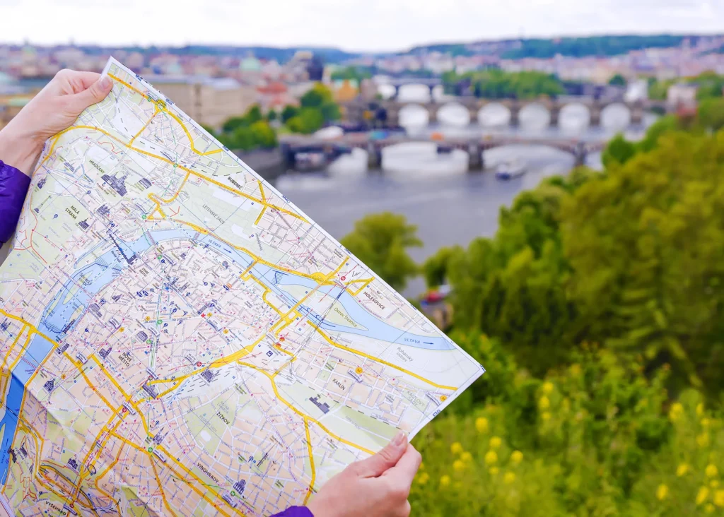 A close up of a city map discovering the neighbourhoods of Prague, Czech Republic, while overlooking the bridges over the Vltava river.