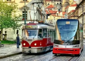 Prague's public transport - two trams driving through the historical centre of Prague, UNESCO heritage site.