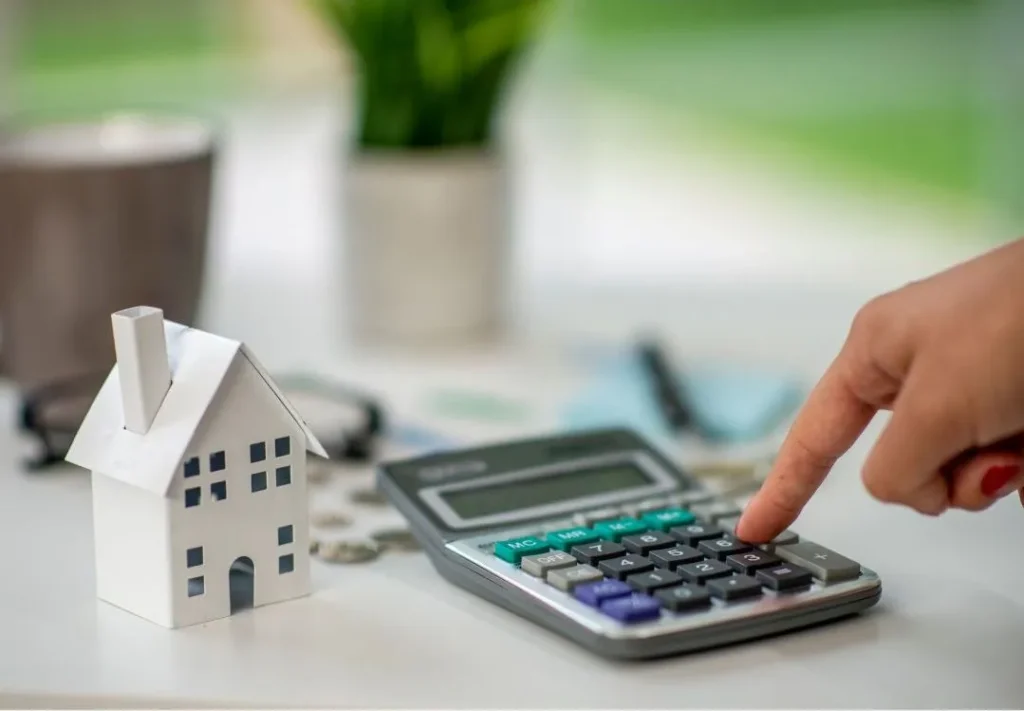 Mortgages in the Czech Republic, a close up of calculator and a mock up of a house.